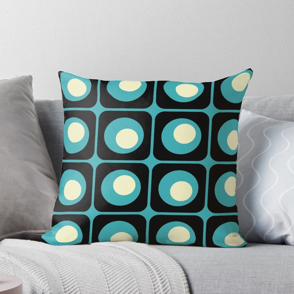 Retro geometric pillow with a vibrant gradient square and circle pattern in a midcentury modern style.