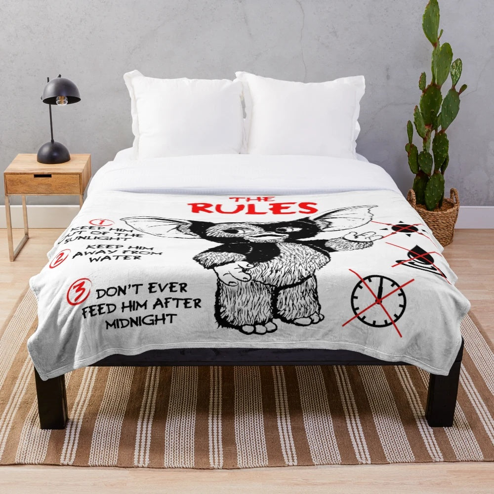 Gremlins plush blanket featuring Gizmo the mogwai and other 80s monster characters