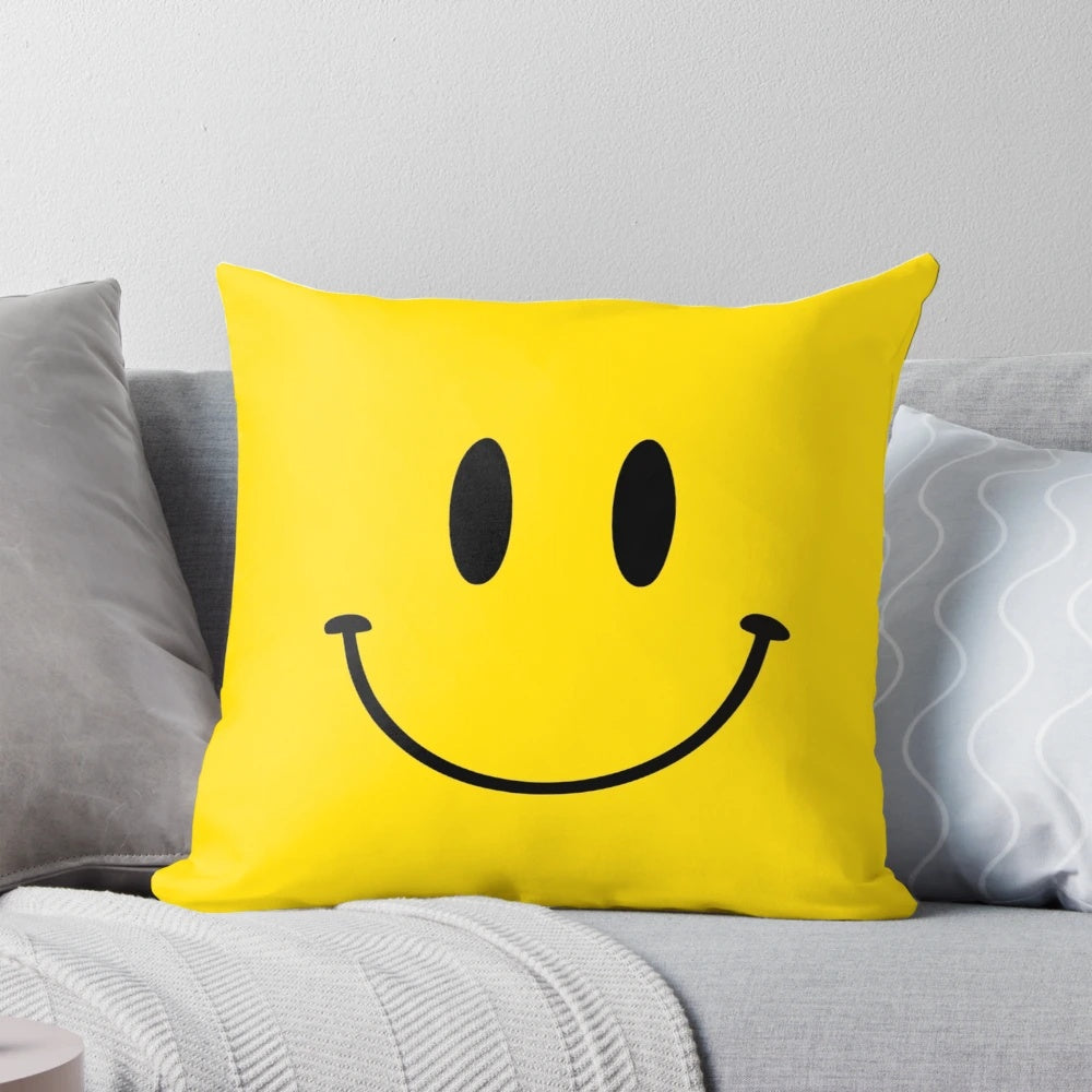 Colorful square throw pillow with a happy face design in a retro, nostalgic style