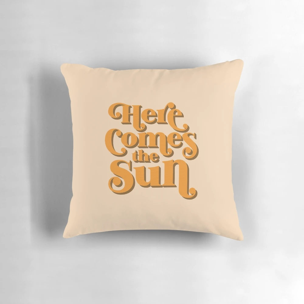 Retro throw pillow featuring the iconic lyrics "Here Comes the Sun" from The Beatles' classic song.
