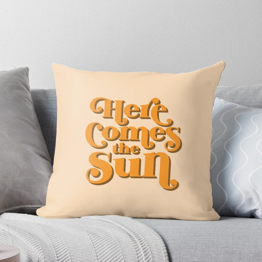 Retro throw pillow featuring the iconic lyrics "Here Comes the Sun" from The Beatles' classic song.