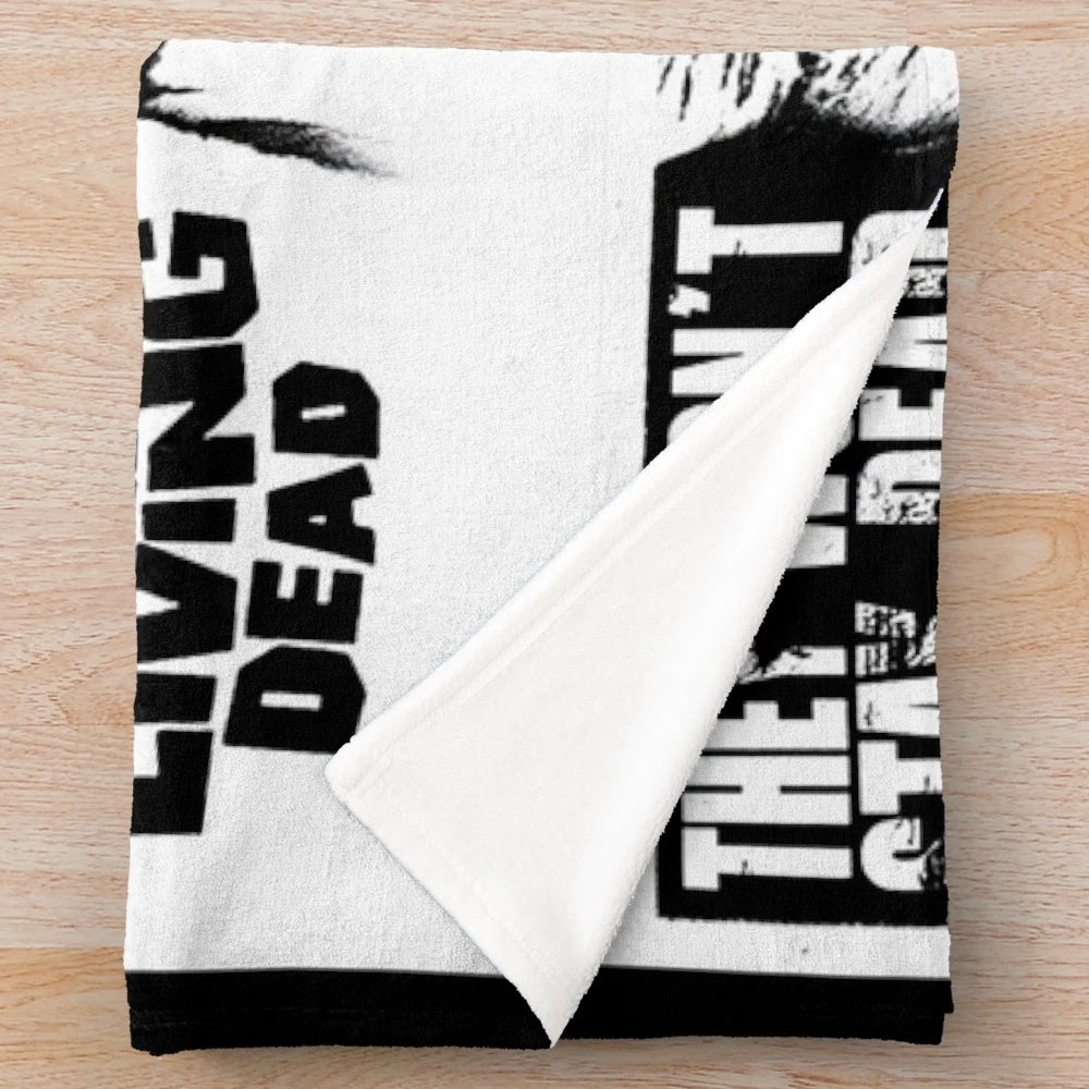 Retro horror-themed plush blanket with zombie movie design