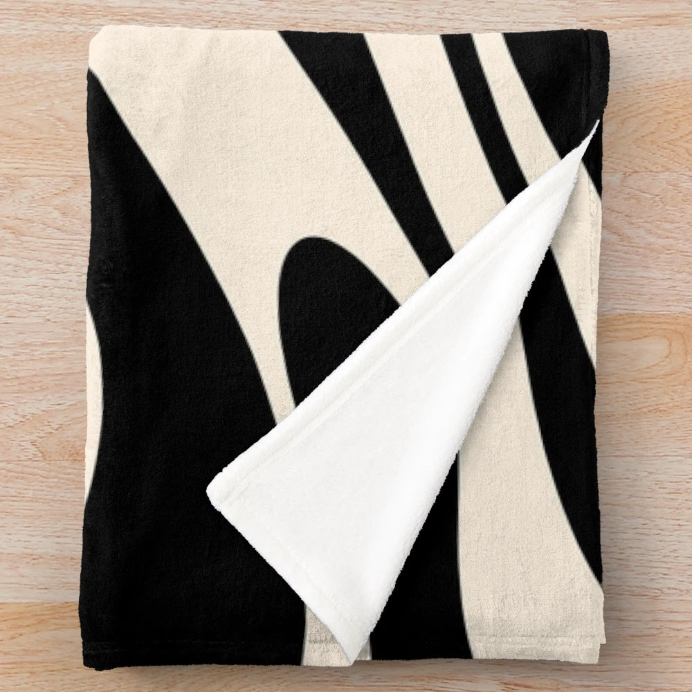 Retro abstract plush blanket in black and cream tones