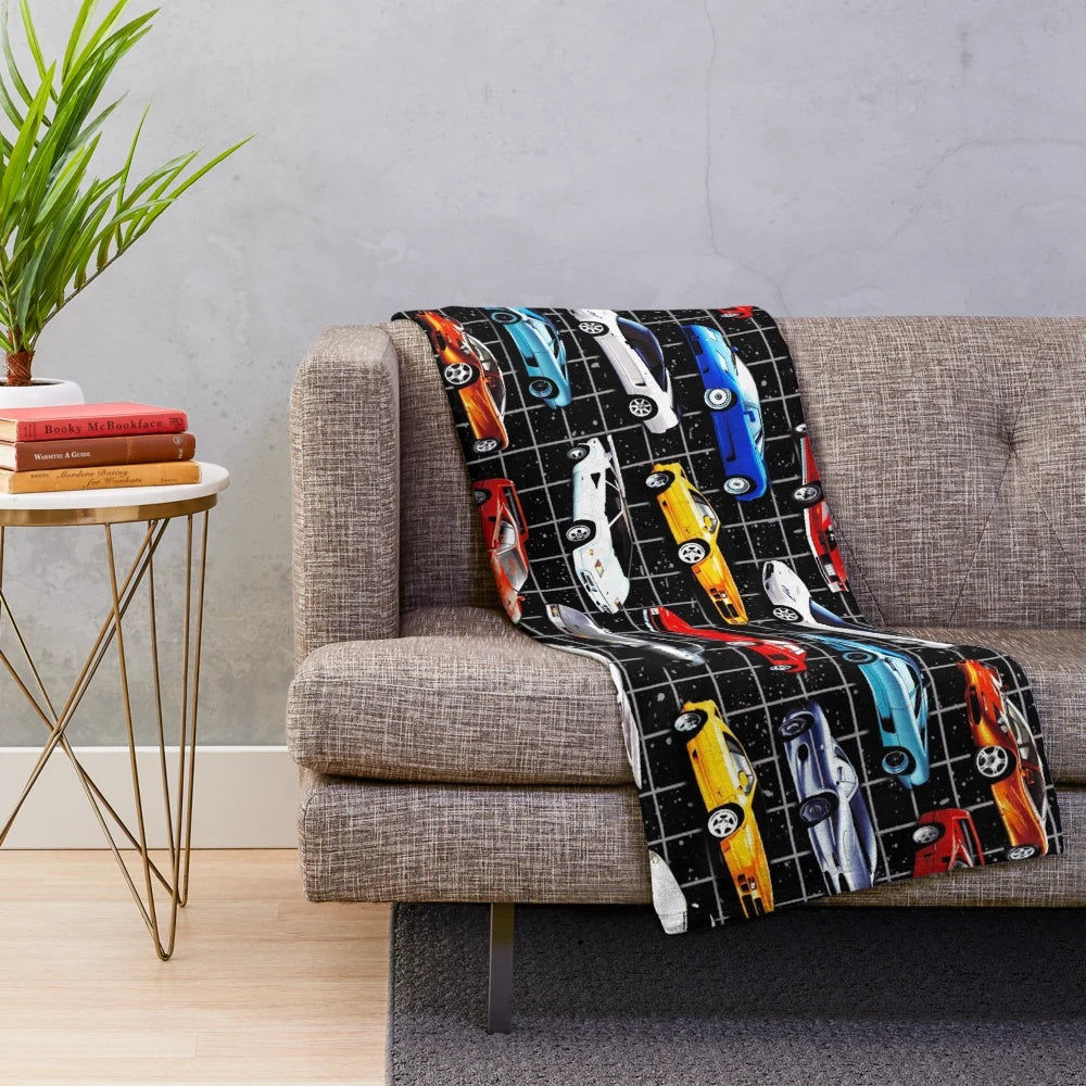 Plush blanket featuring a collage of classic 1980s sports cars in a retro-inspired, synthwave style