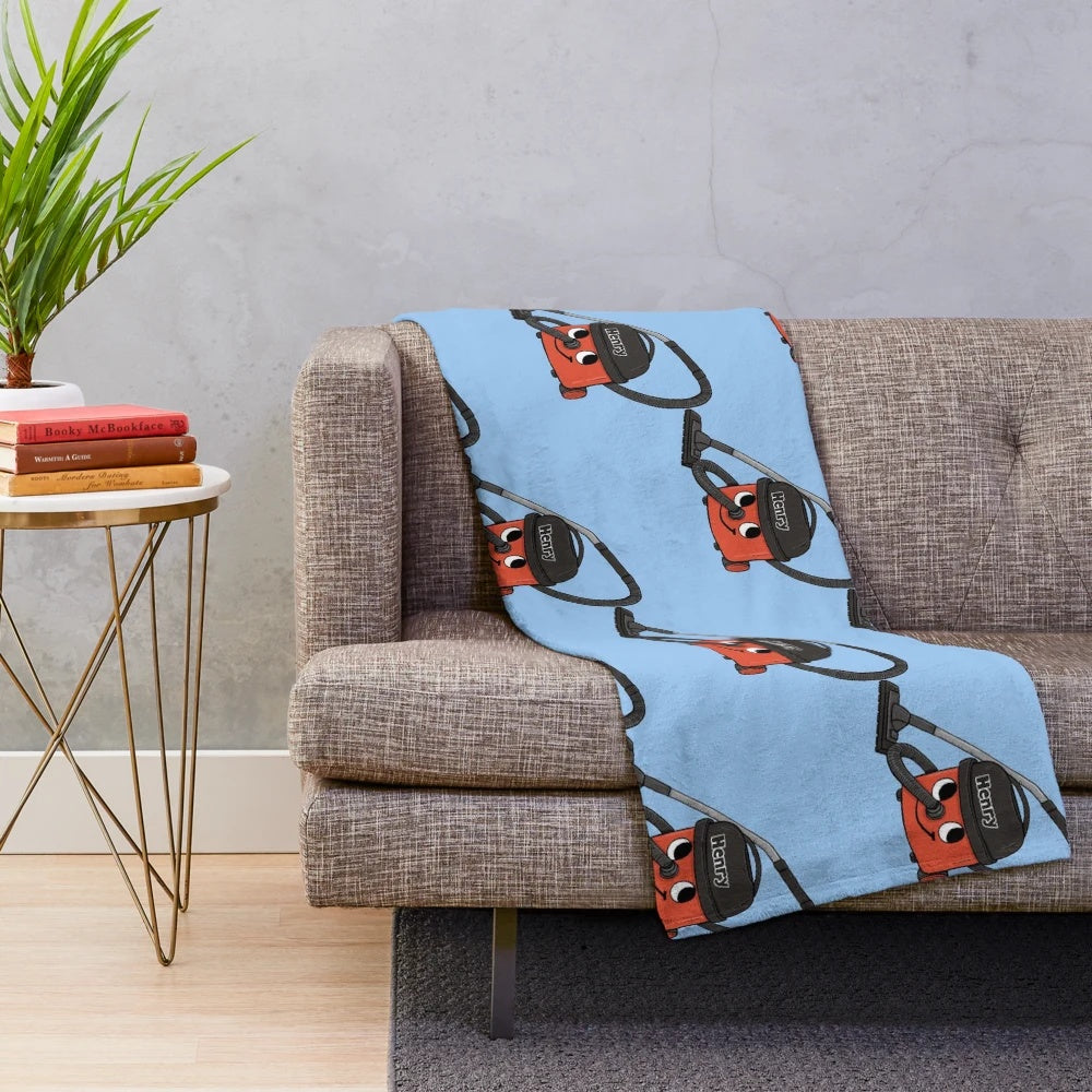 Plush blanket featuring a retro-inspired design of the iconic Henry Hoover vacuum cleaner