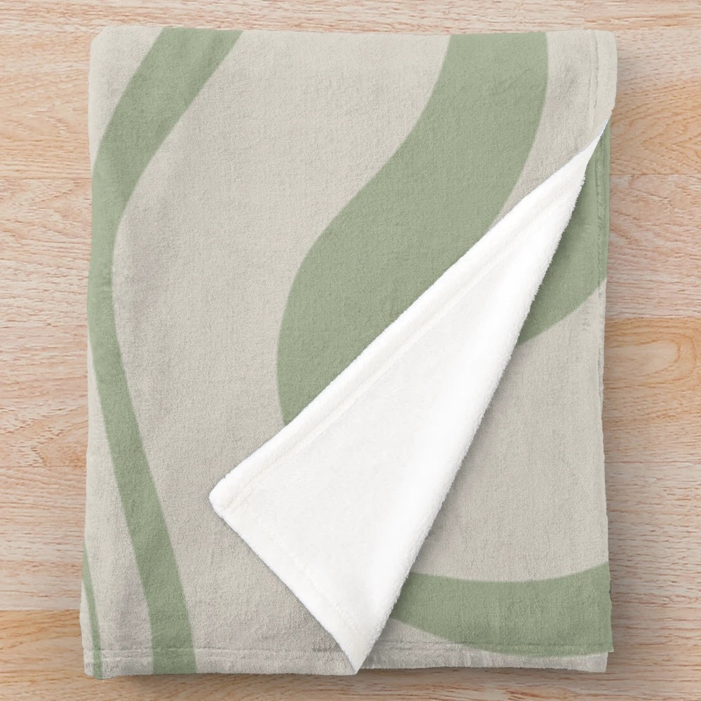 Plush blanket with abstract swirl pattern in beige and sage green