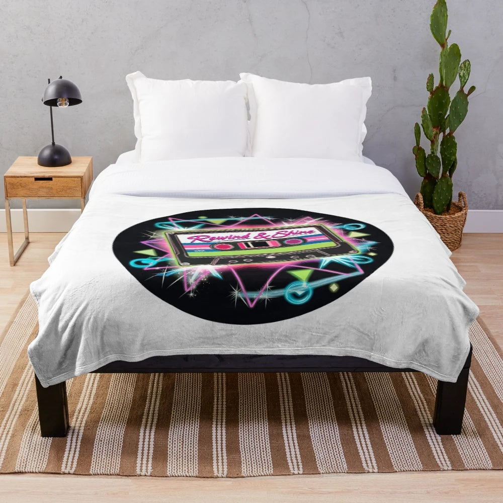 Retro 80s style plush blanket with neon colored cassette tape illustration and geometric patterns