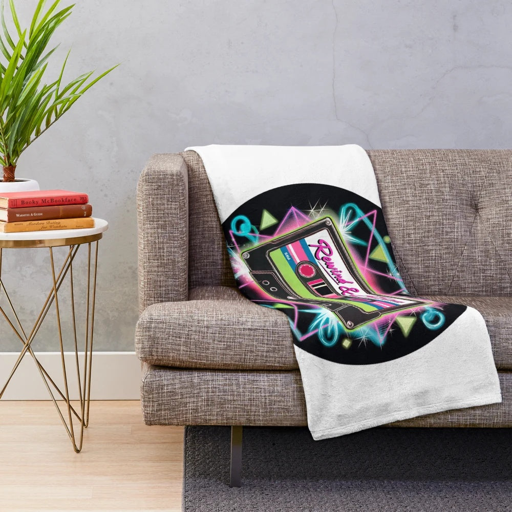 Retro 80s style plush blanket with neon colored cassette tape illustration and geometric patterns