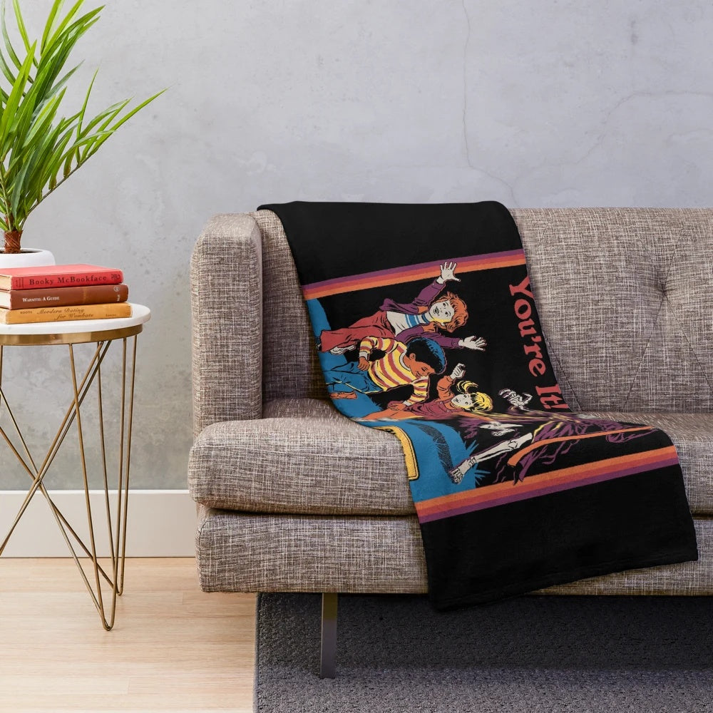 Plush blanket with a retro-inspired, dark humor grim reaper design