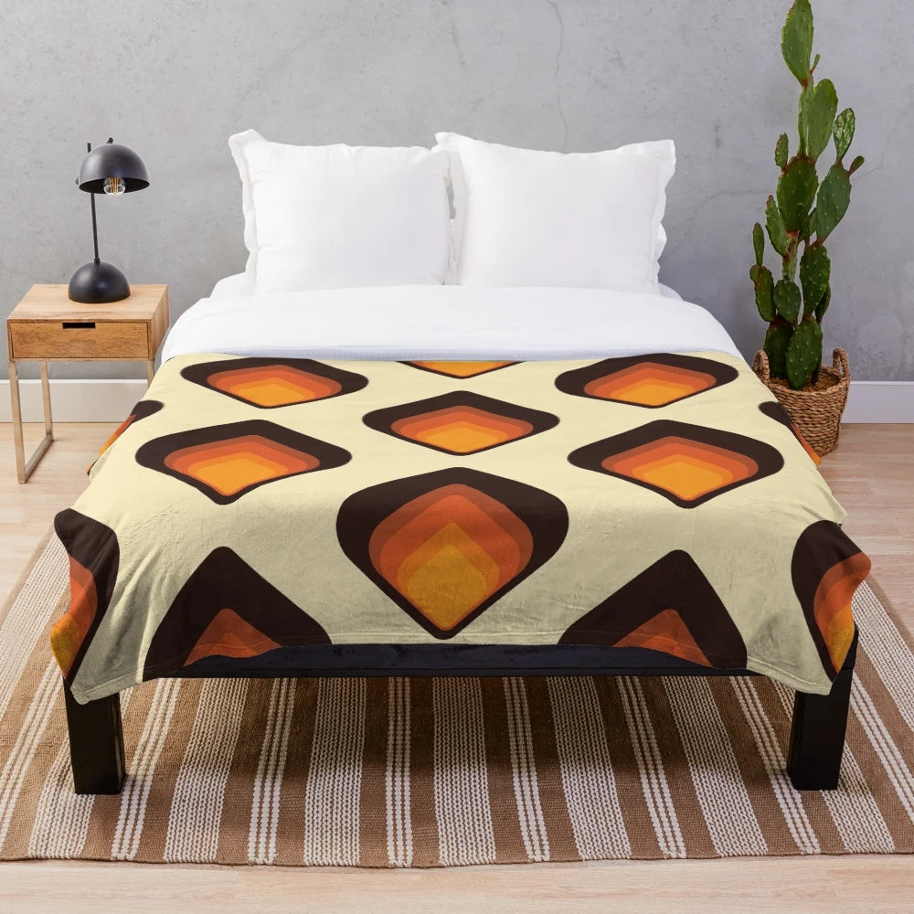Mid-century modern style plush blanket with geometric tear drop pattern in orange and brown colors