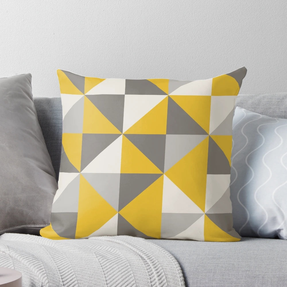 Stylish retro-inspired pillow with a bold triangle pattern in vibrant yellow and neutral gray tones