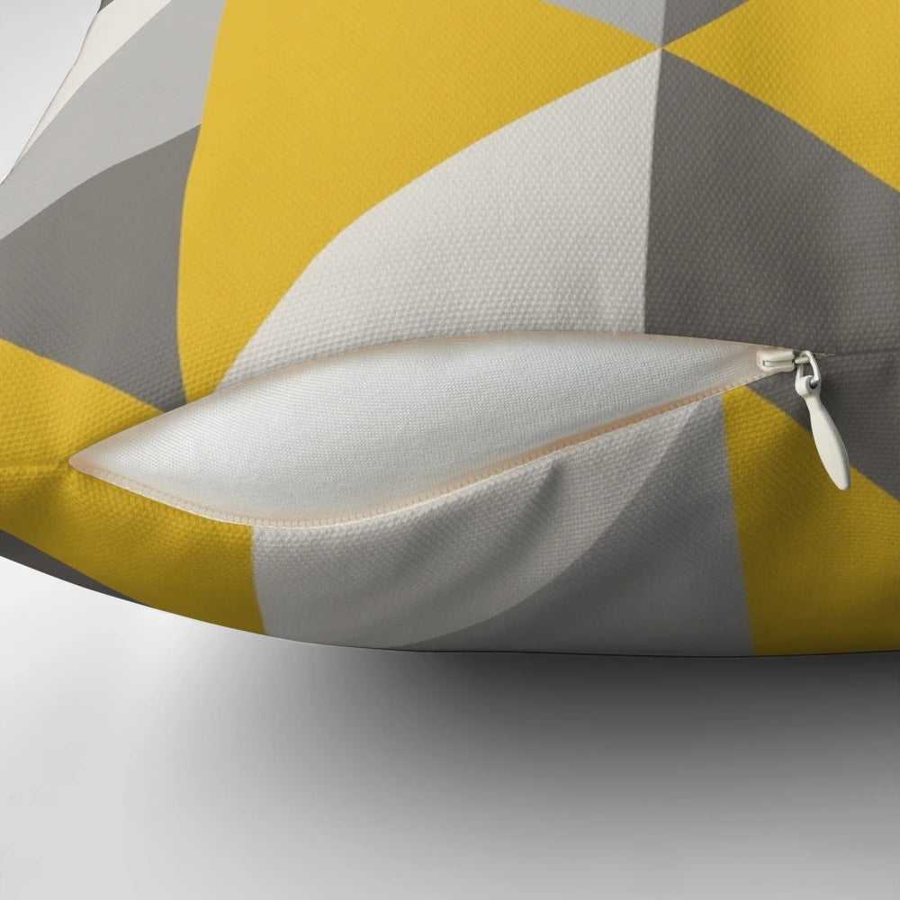 Stylish retro-inspired pillow with a bold triangle pattern in vibrant yellow and neutral gray tones