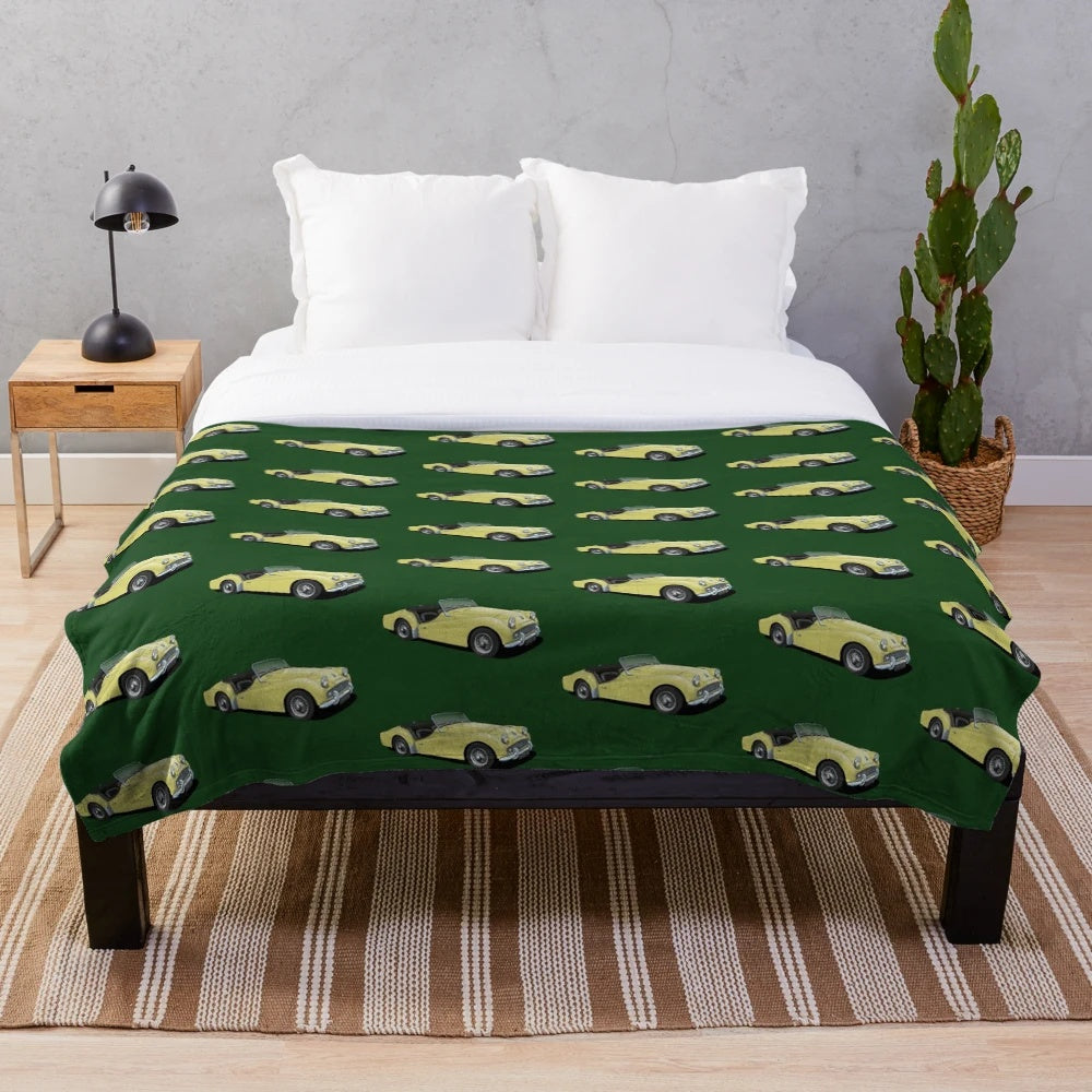 Plush blanket featuring a vintage Triumph TR3 sports car in yellow