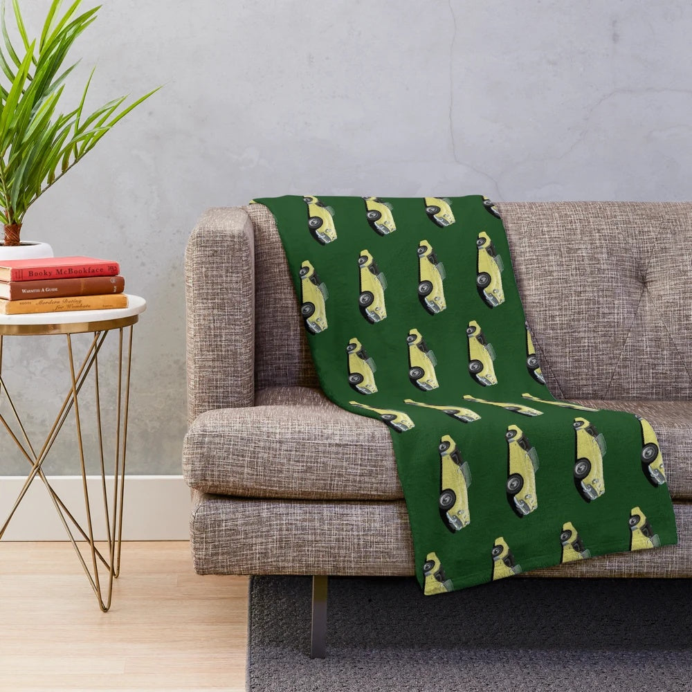 Plush blanket featuring a vintage Triumph TR3 sports car in yellow