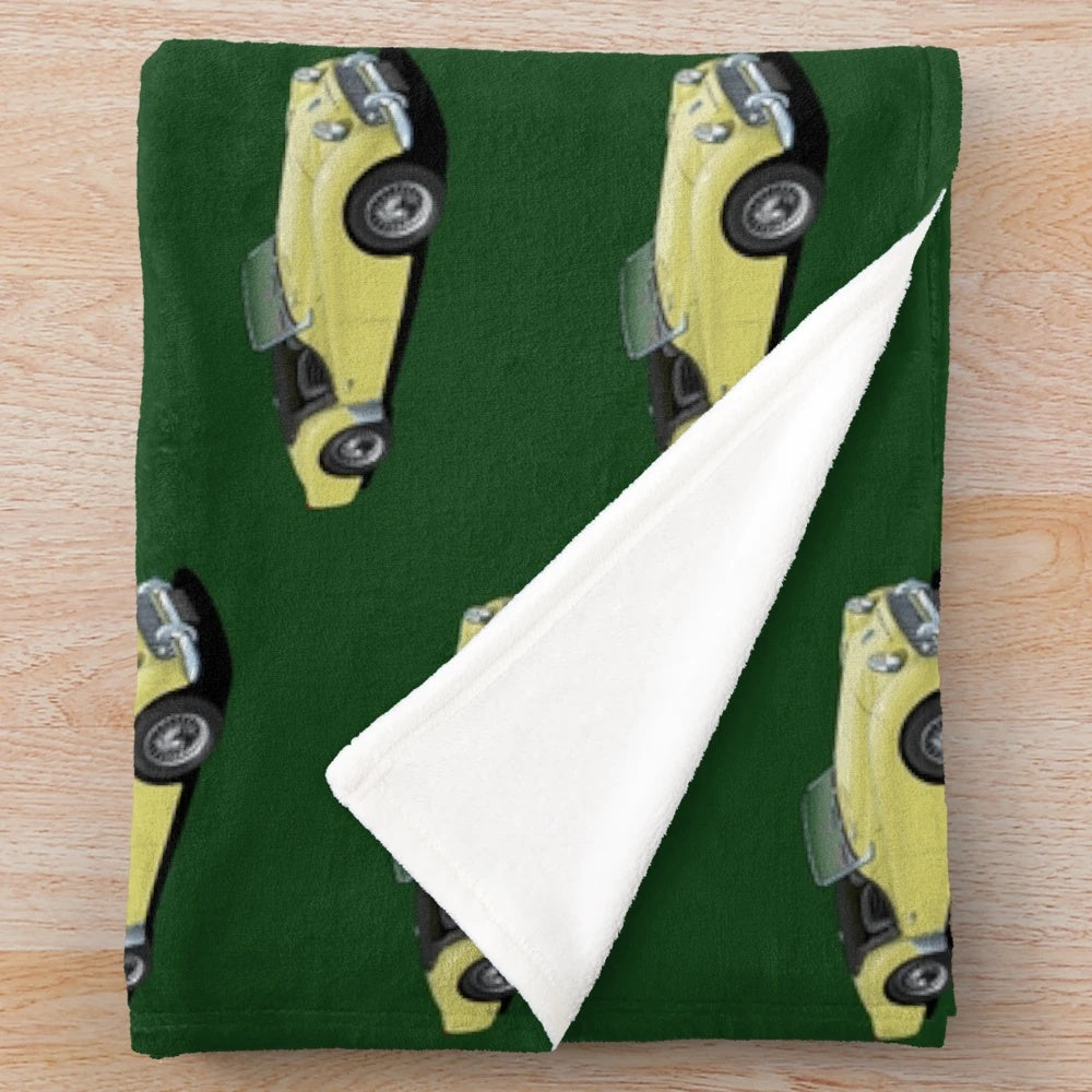 Plush blanket featuring a vintage Triumph TR3 sports car in yellow