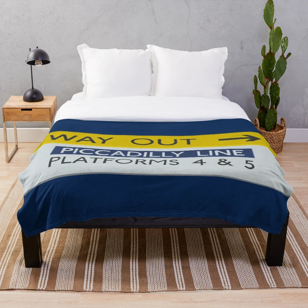 Cozy plush blanket featuring a London Underground Picadilly Line "Way Out" sign design