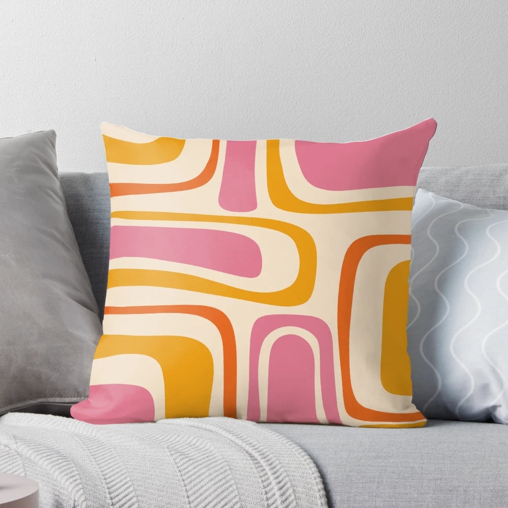 A stylish mid century modern abstract pattern throw pillow in shades of pink and orange