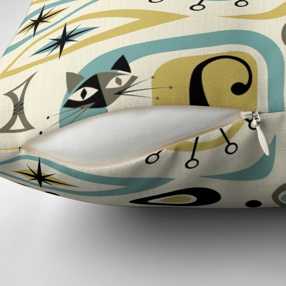 A vibrant mid-century style pillow featuring an abstract design with playful atomic-inspired cats in shades of blue, gold, and gray.