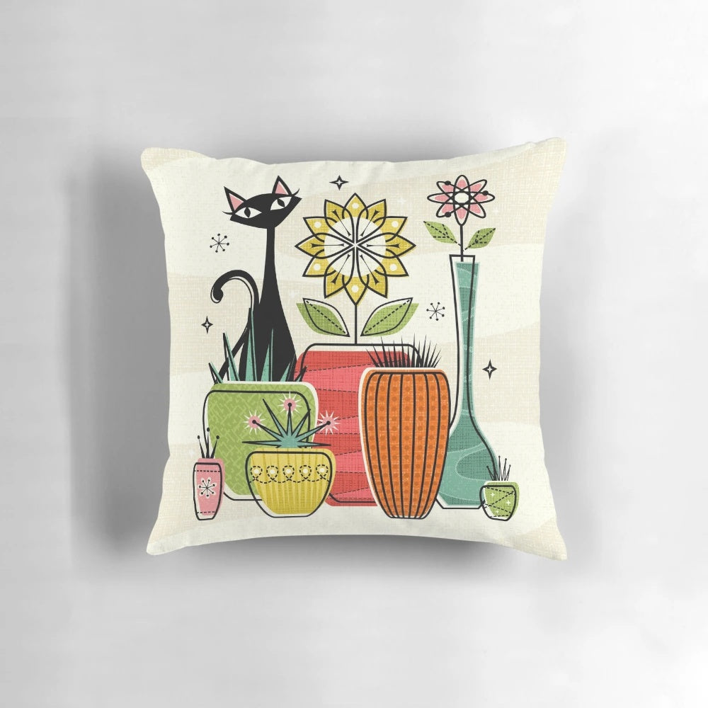 A decorative throw pillow featuring a vintage-inspired illustration of a black cat among houseplants and atomic flowers.
