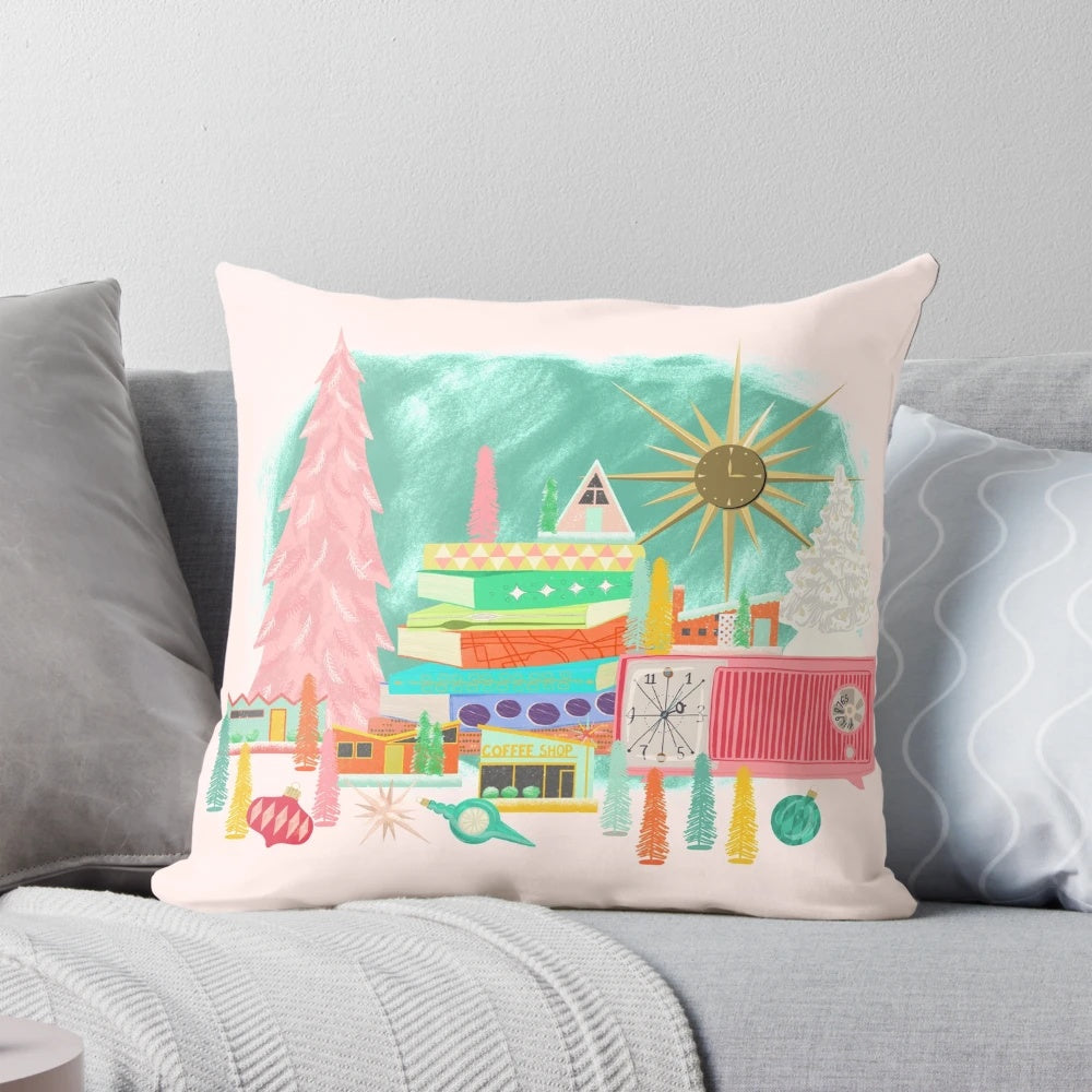 A mid century modern-inspired Christmas pillow featuring a vintage-style scene with a pink Christmas tree, starburst, and stack of books.