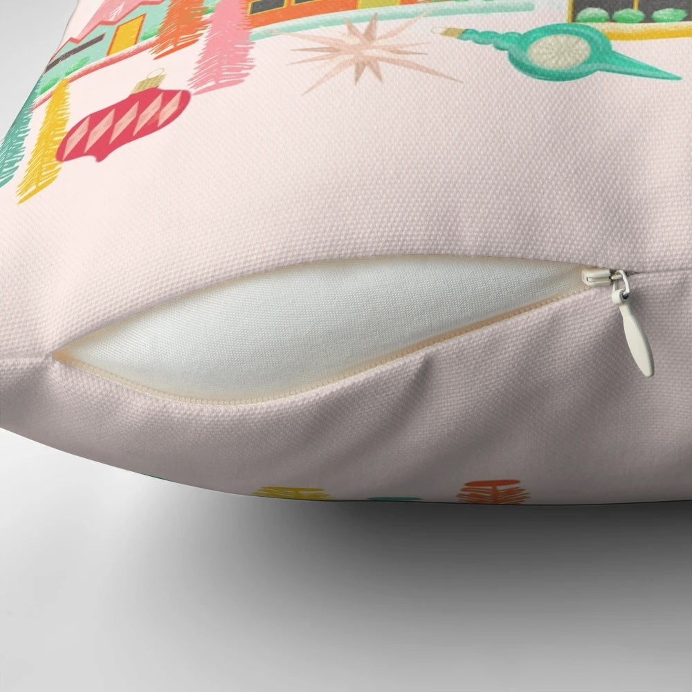 A mid century modern-inspired Christmas pillow featuring a vintage-style scene with a pink Christmas tree, starburst, and stack of books.