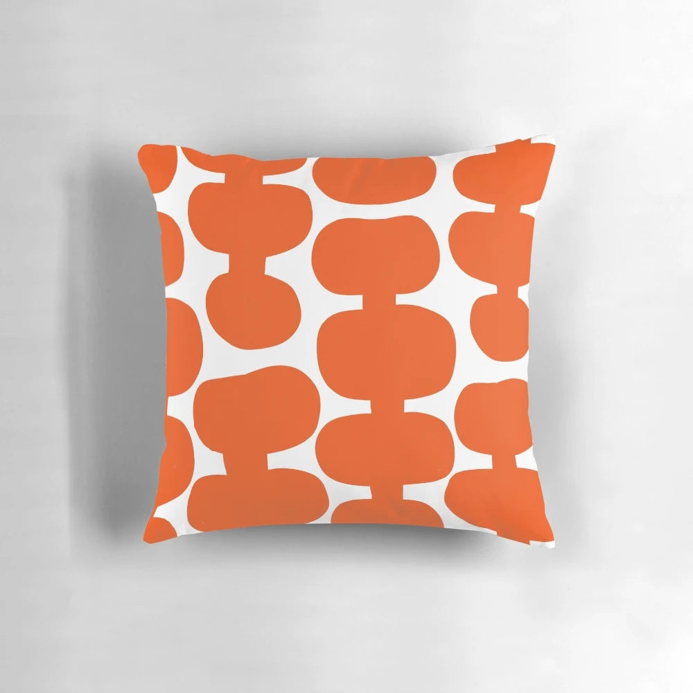 A white and orange mid century modern floral pattern pillow