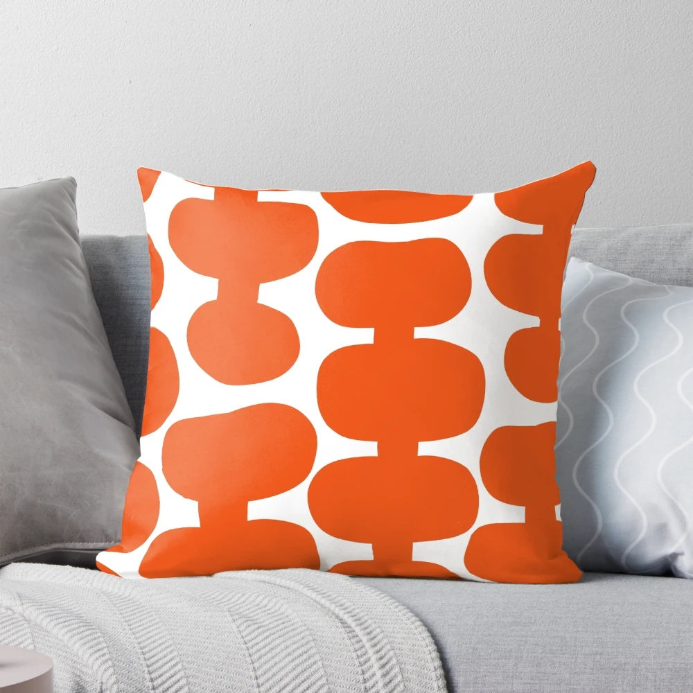A white and orange mid century modern floral pattern pillow