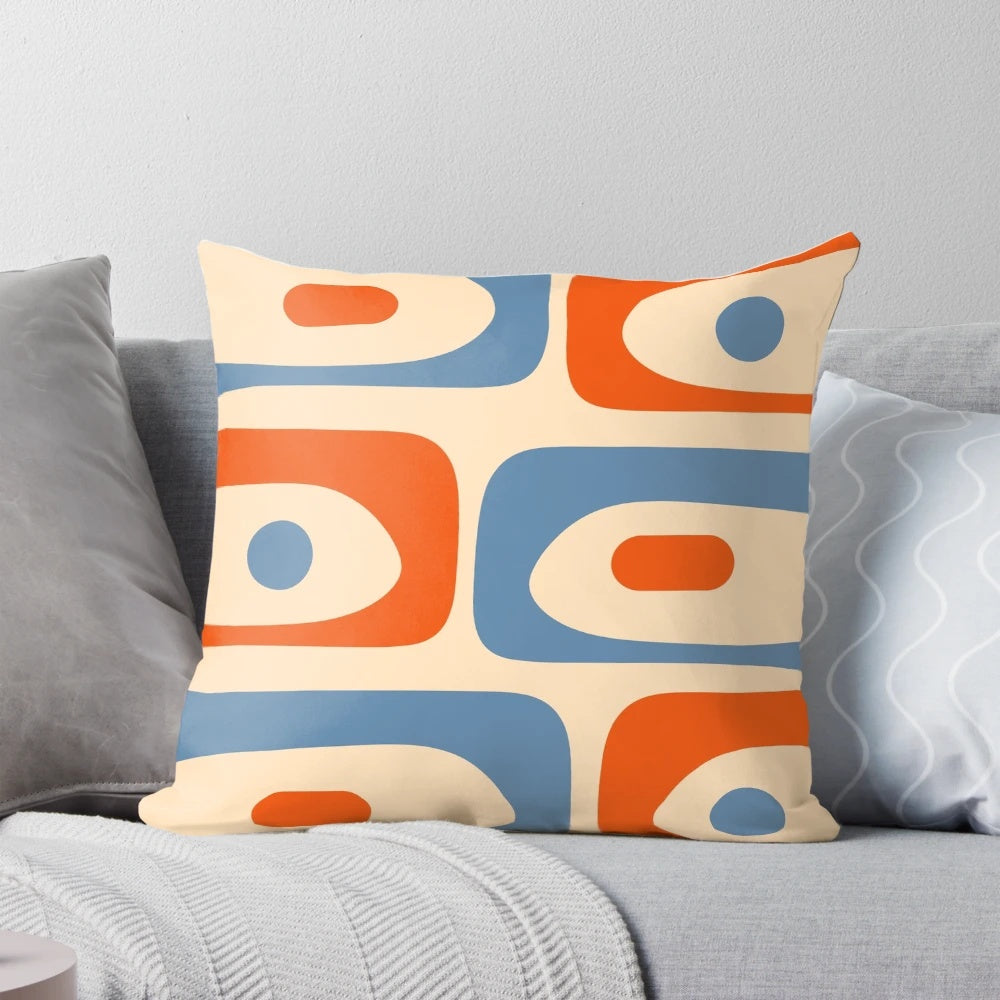 Vibrant mid-century modern patterned pillow in shades of orange and blue