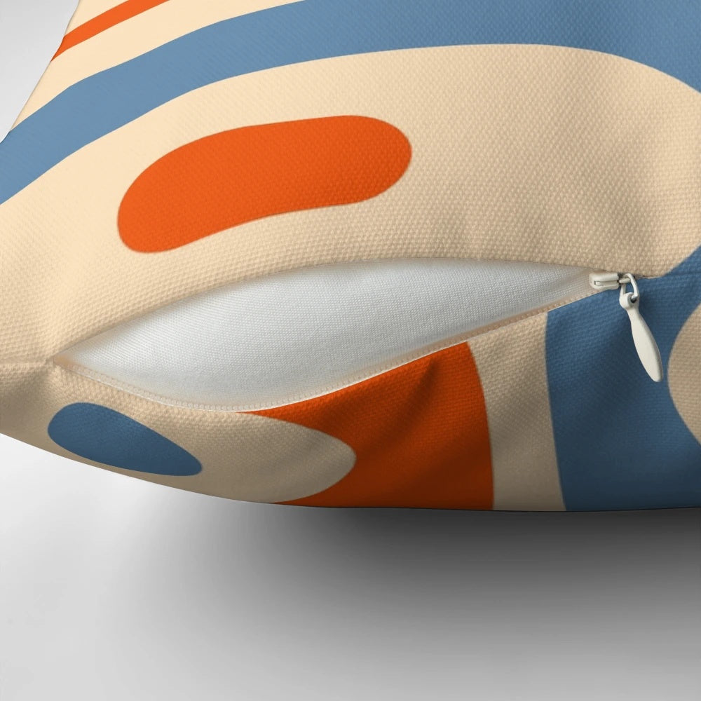 Vibrant mid-century modern patterned pillow in shades of orange and blue