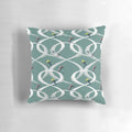 Vintage-style illustration of two skiers on a teal mid century modern throw pillow