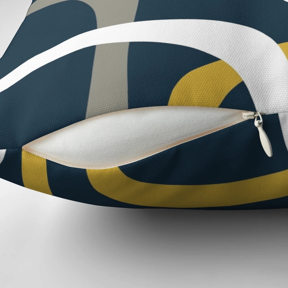 Midcentury modern inspired throw pillow with a geometric abstract pattern in light mustard, grey, white, and navy blue.