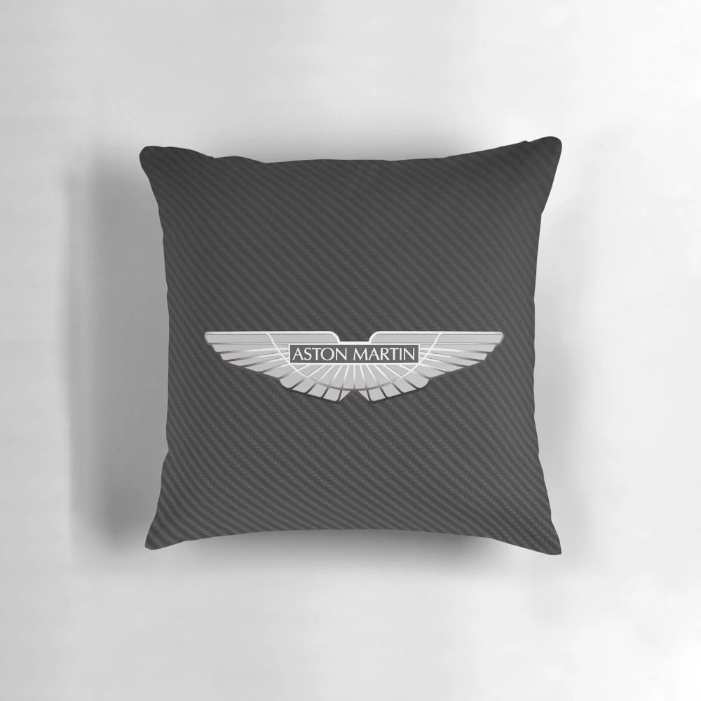 Aston Martin logo on a black carbon fiber background printed on a throw pillow