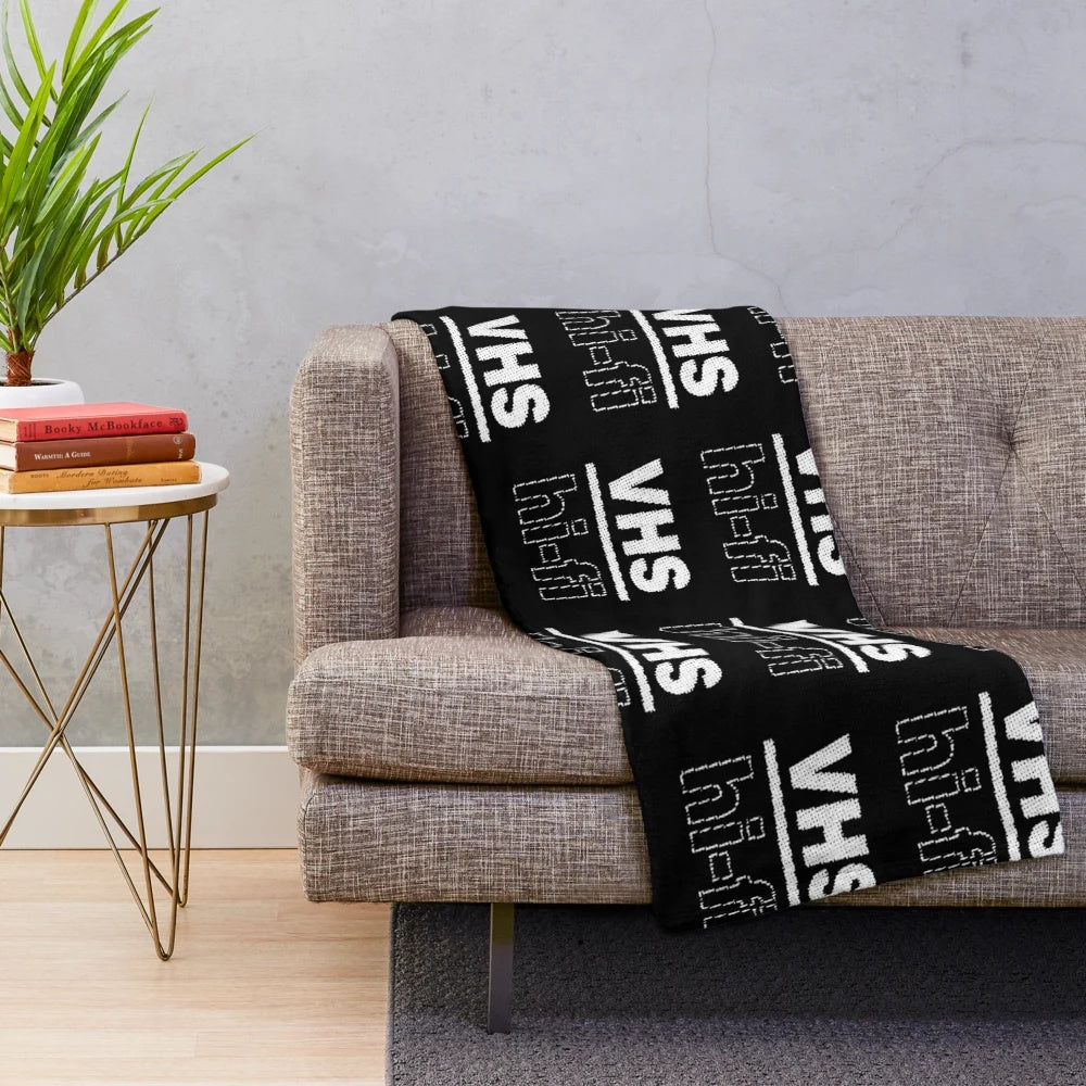 Plush blanket with retro VHS-inspired design