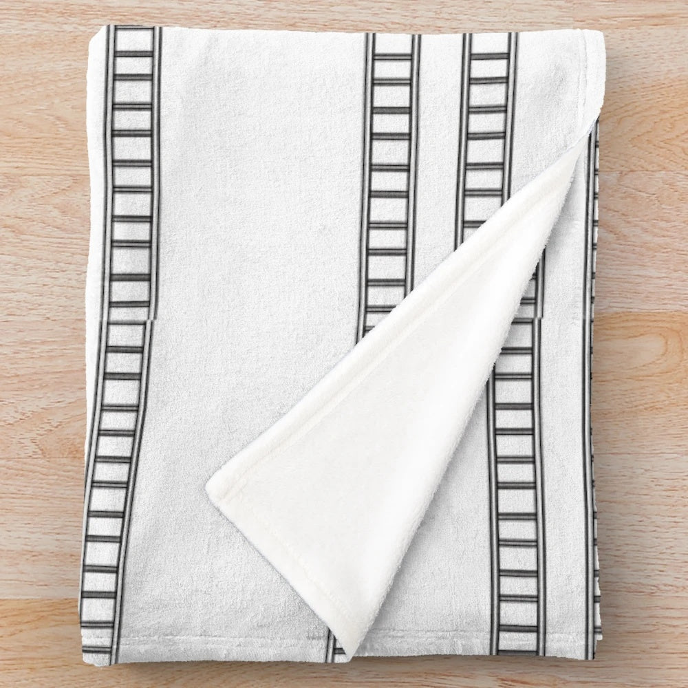 Retro movie strip inspired plush blanket with a cozy, cinema-inspired design
