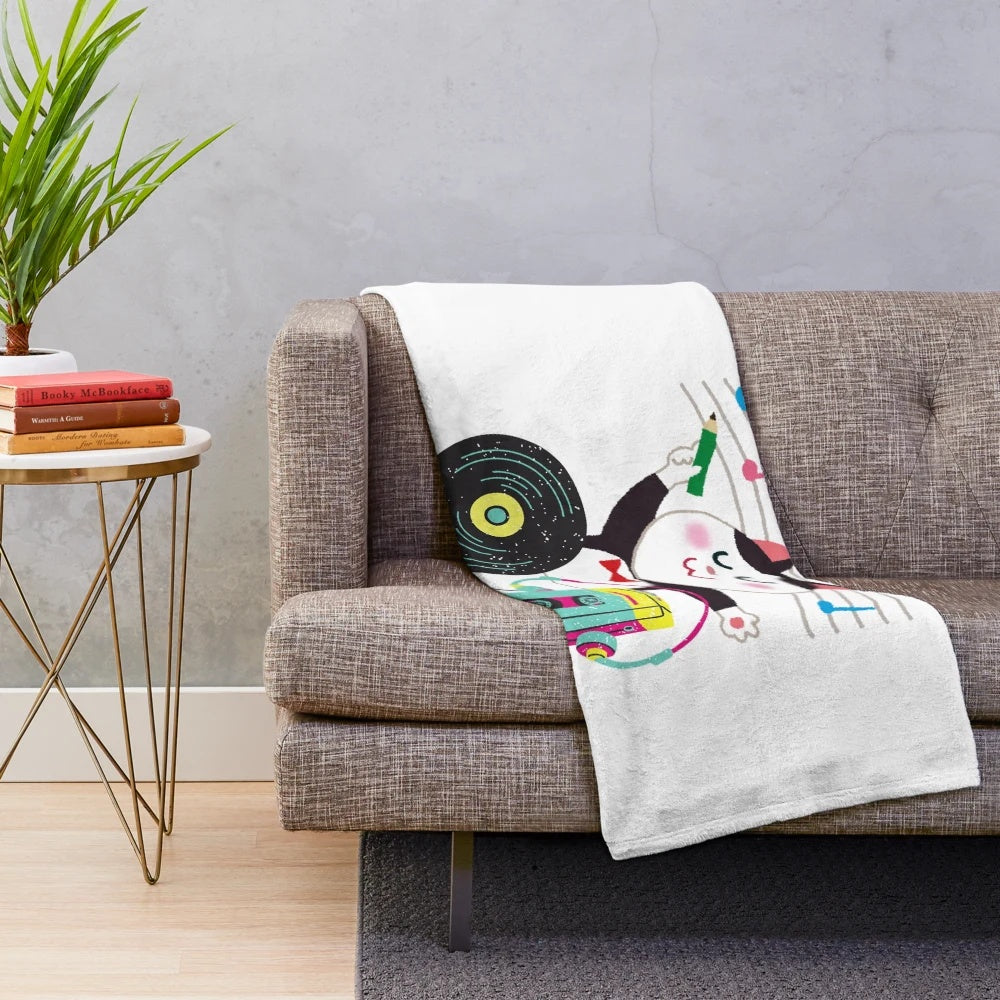 Retro music plush blanket with cassette tapes, headphones, and musical notes