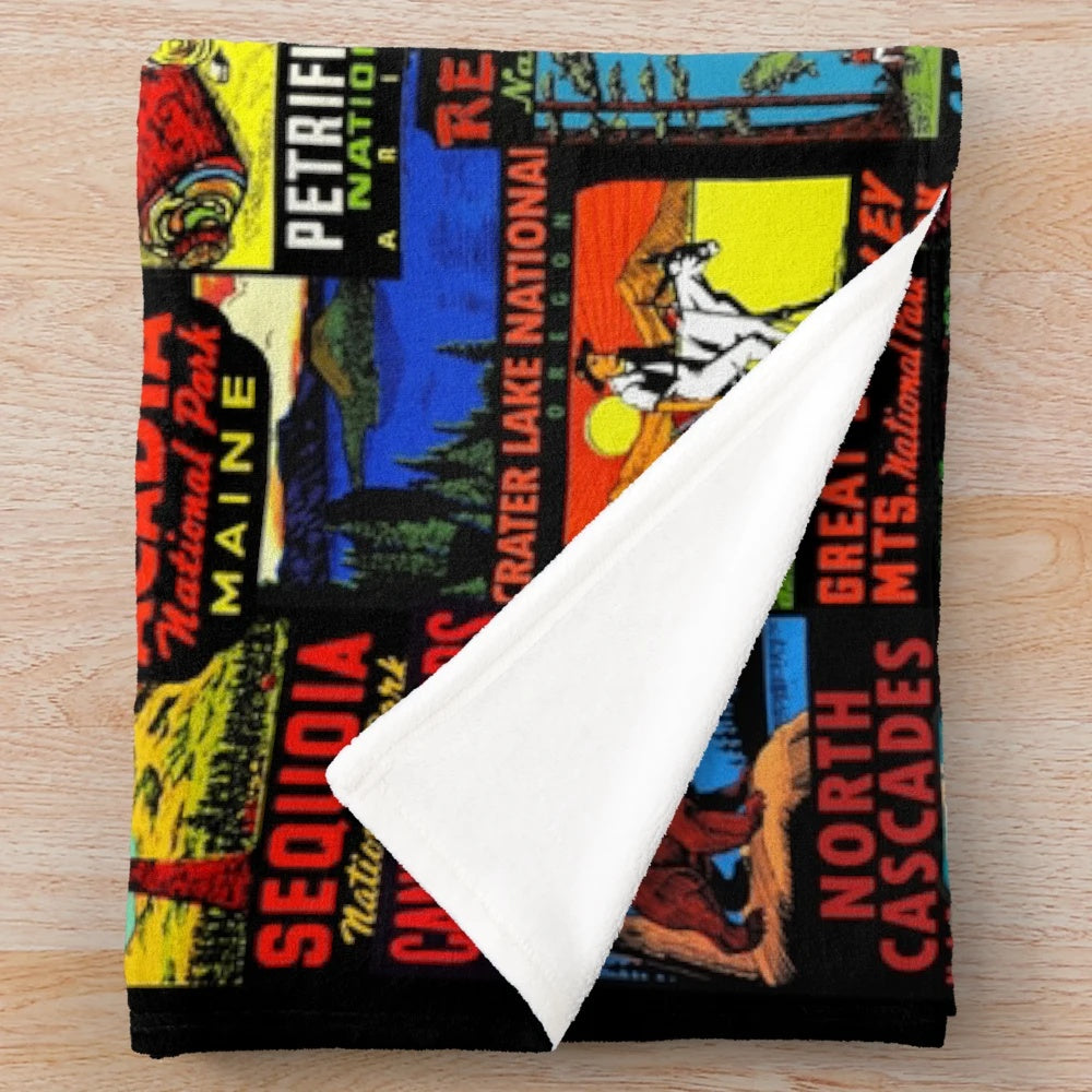 Vintage-style plush blanket featuring a collage of national park travel decals