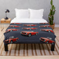 Plush blanket depicting a red Triumph TR6 sports car, a classic British roadster from the 1970s