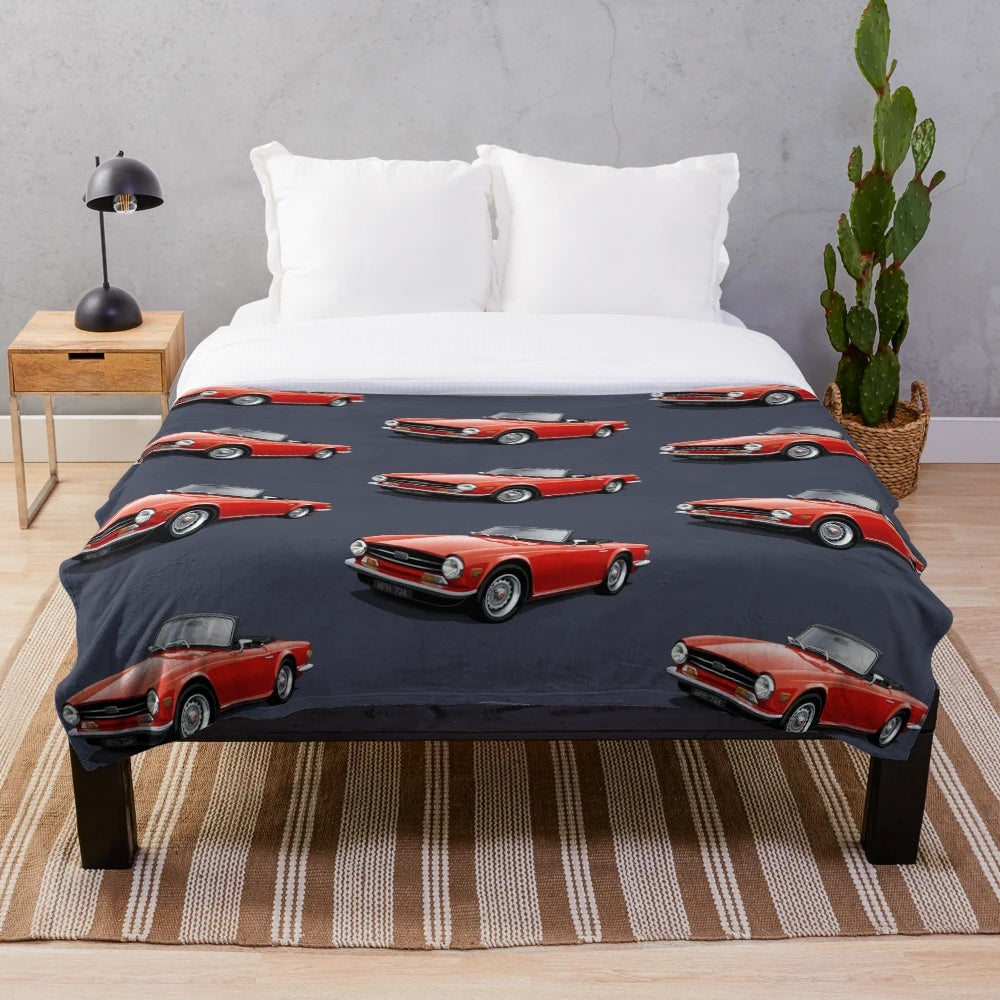 Plush blanket depicting a red Triumph TR6 sports car, a classic British roadster from the 1970s