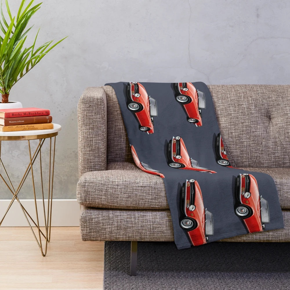 Plush blanket depicting a red Triumph TR6 sports car, a classic British roadster from the 1970s