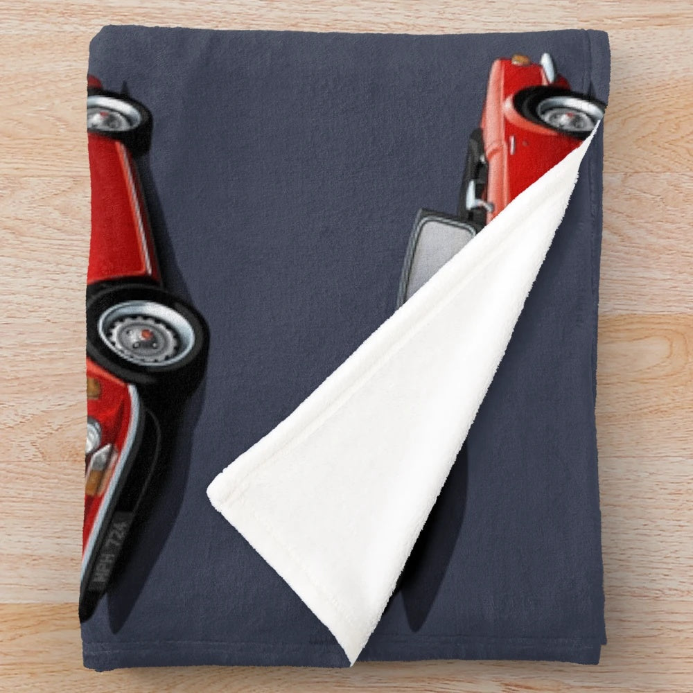 Plush blanket depicting a red Triumph TR6 sports car, a classic British roadster from the 1970s