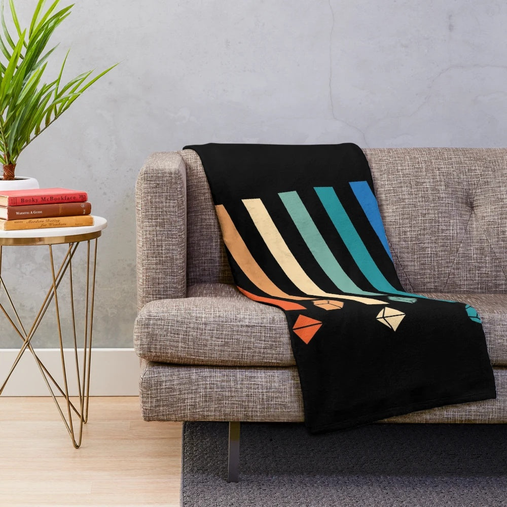 Vintage-style plush blanket featuring a rainbow dice design for RPG and tabletop gaming fans