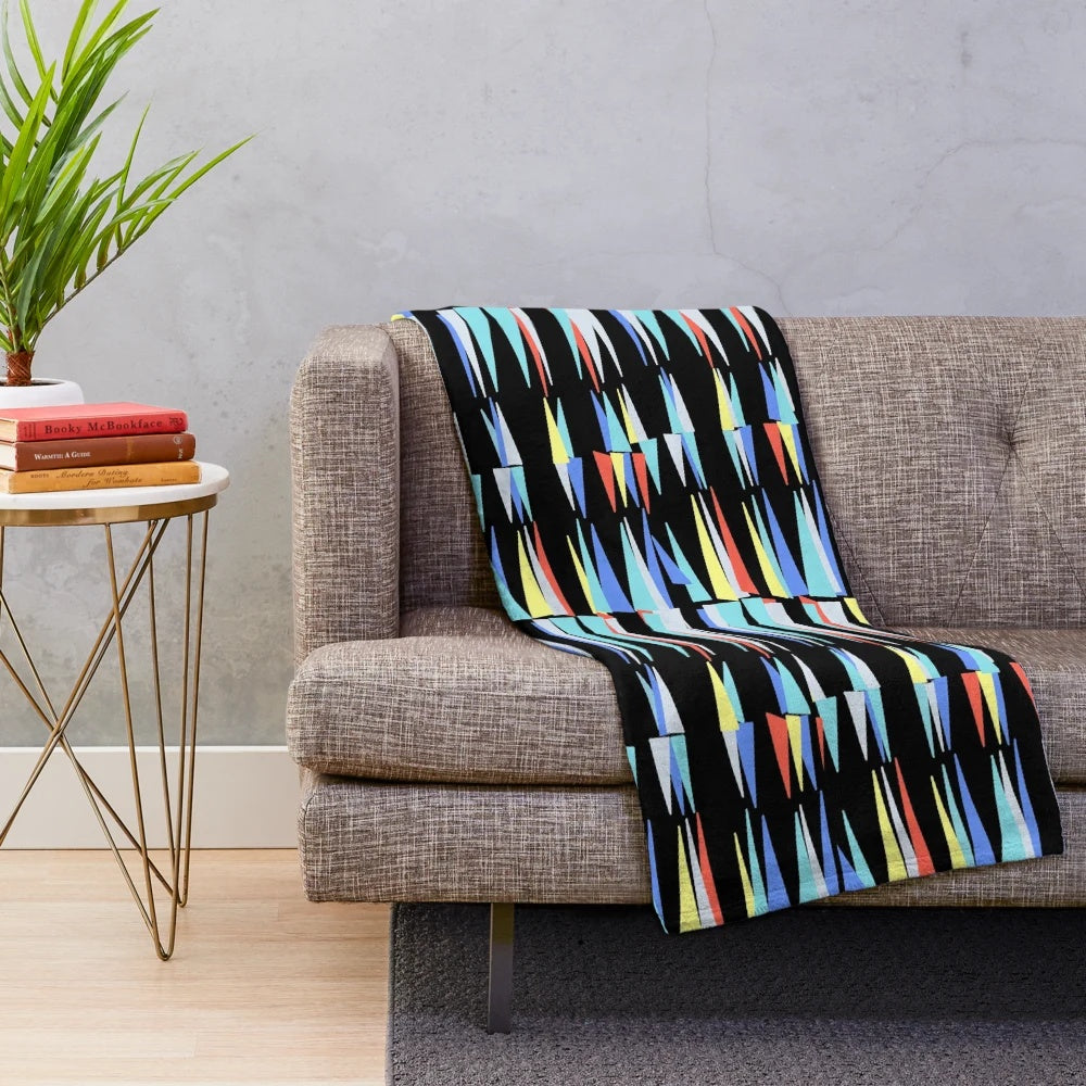 Plush blanket with retro triangle pattern inspired by a classic Scottish cafe