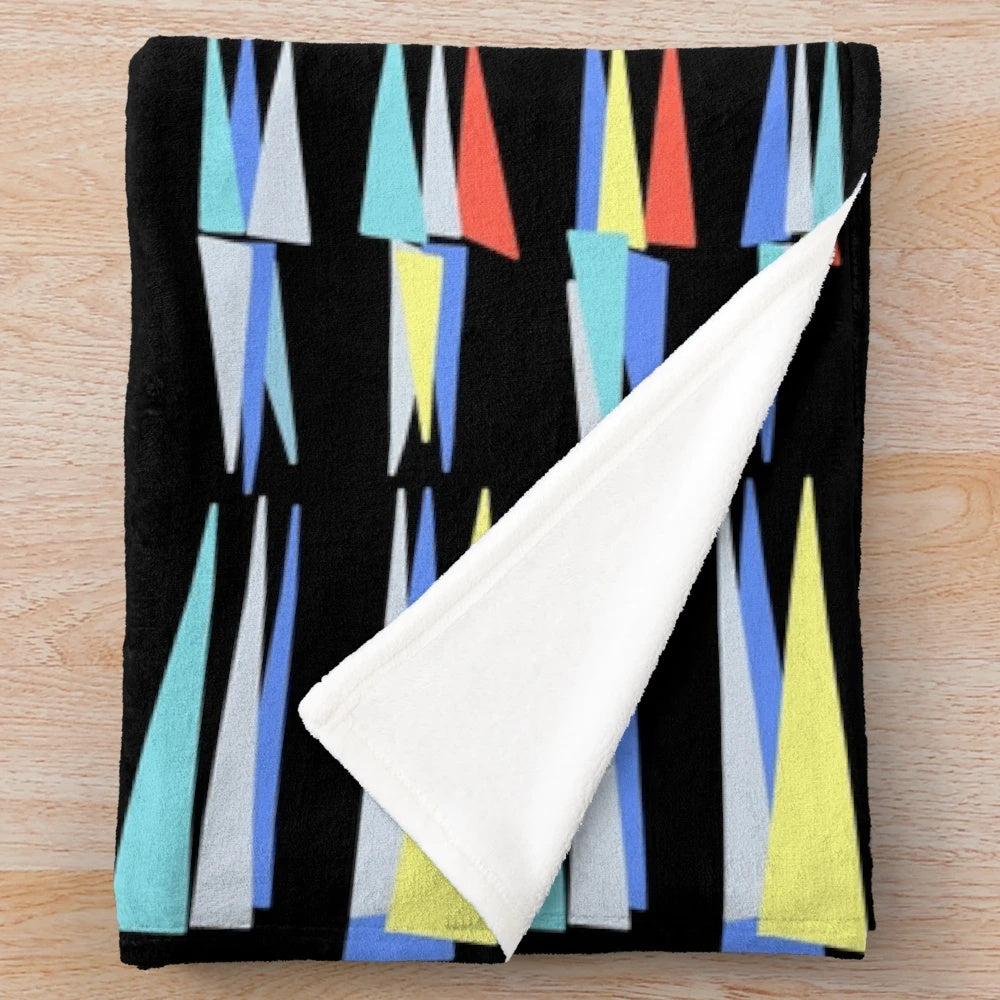 Plush blanket with retro triangle pattern inspired by a classic Scottish cafe