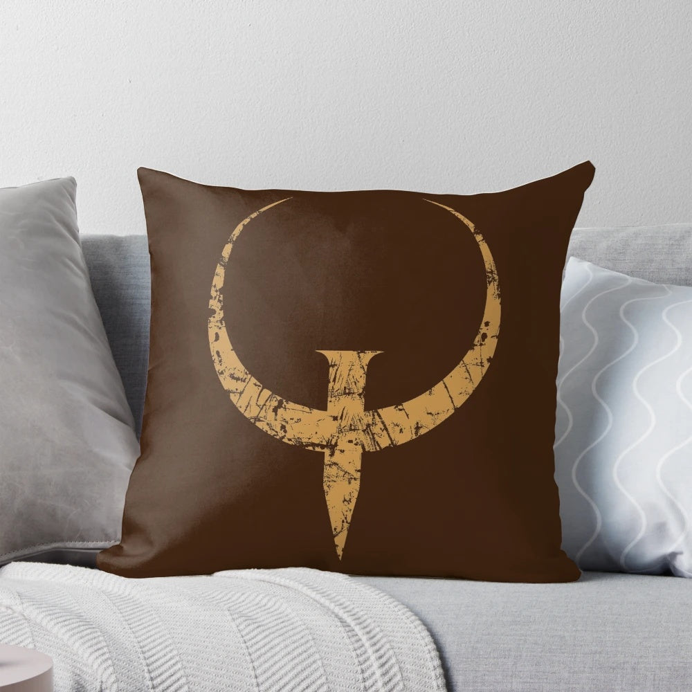 Bronze-colored Quake logo pillow, featuring the iconic FPS game design