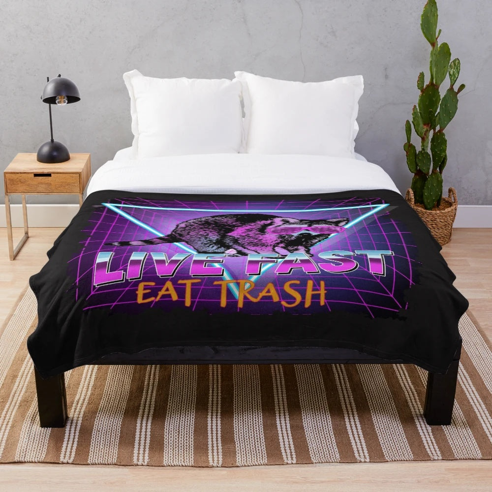 Retro-inspired raccoon plush blanket with "Live Fast Eat Trash" design