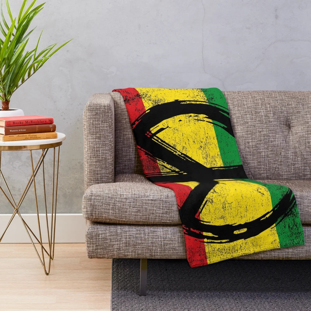 Plush vintage-style blanket featuring a rasta flag design with a peace symbol
