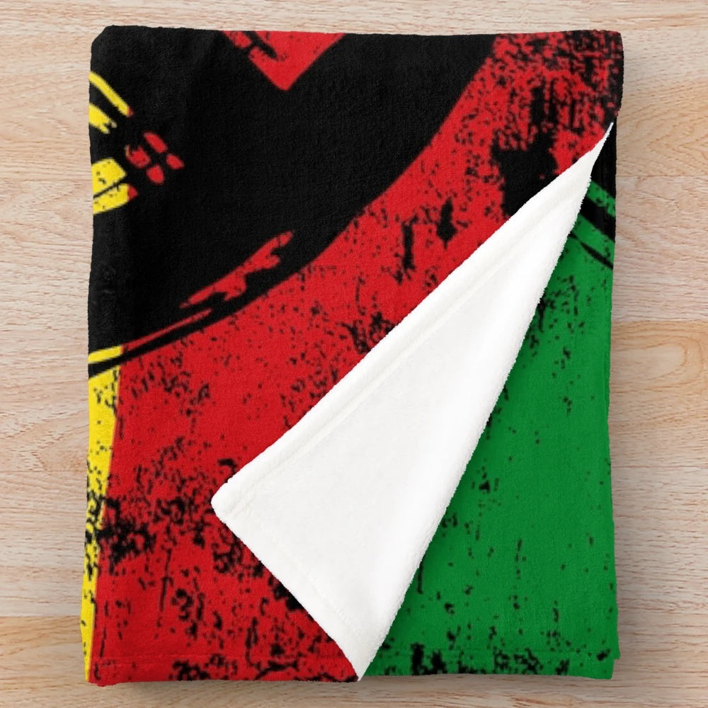 Plush vintage-style blanket featuring a rasta flag design with a peace symbol