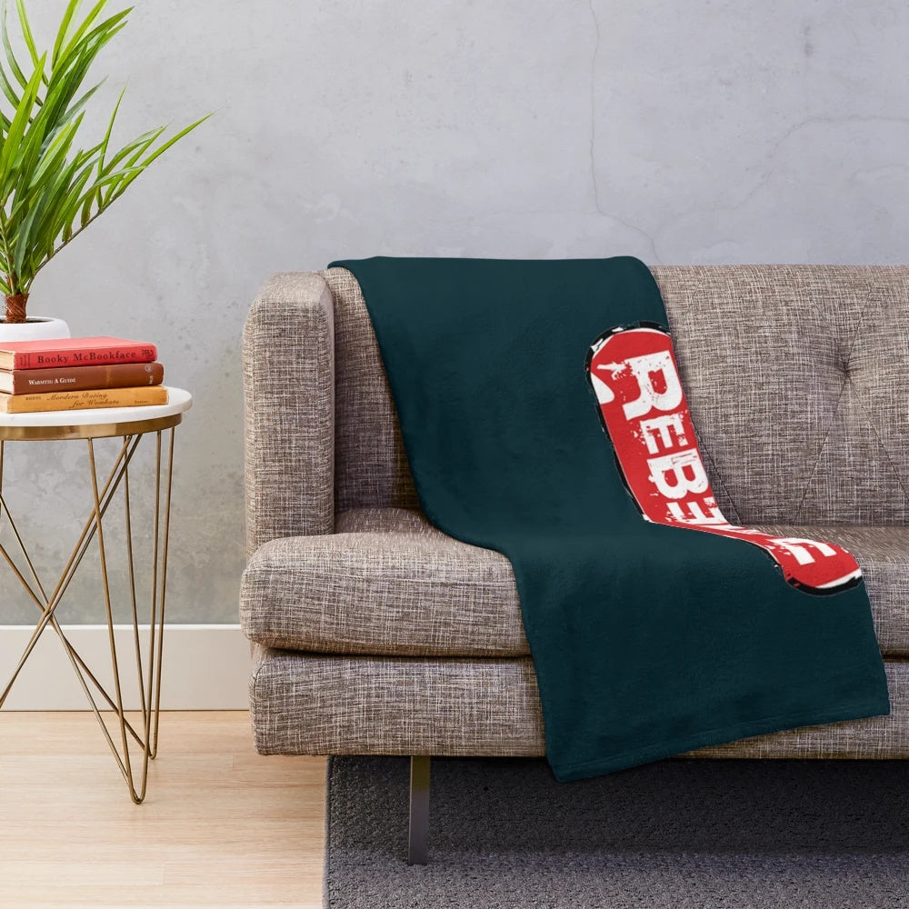Soft and cozy plush blanket featuring the iconic Rebelde logo