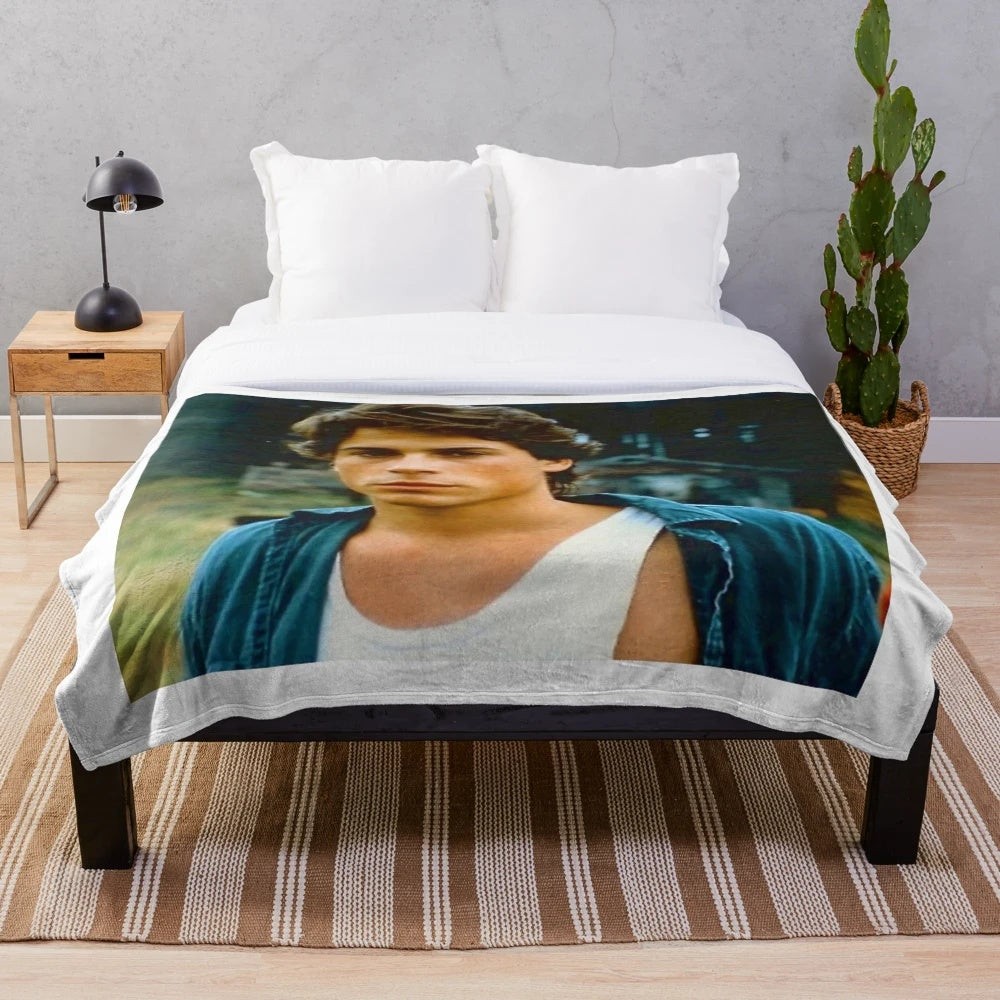 Retro Rob Lowe inspired plush blanket with 80s tv show and movie graphics