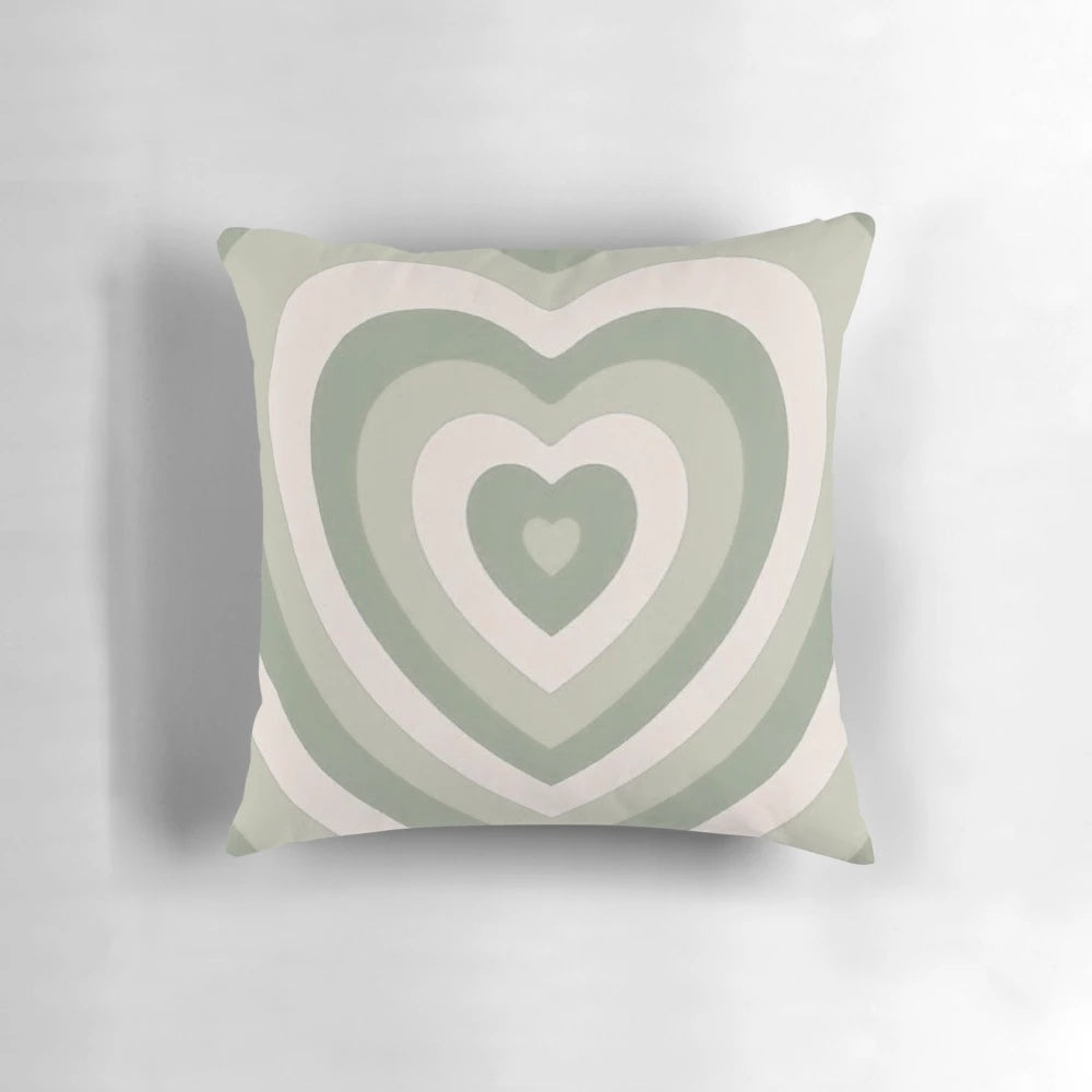 Sage green heart-shaped pillow with a vintage, aesthetic design